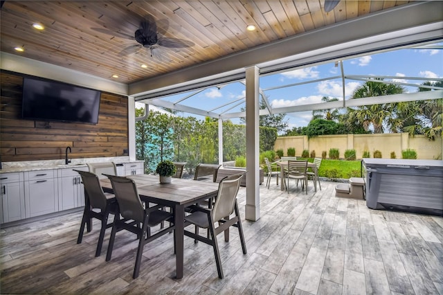 exterior space featuring ceiling fan and wooden ceiling