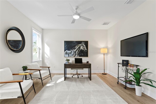 office with ceiling fan and light hardwood / wood-style floors