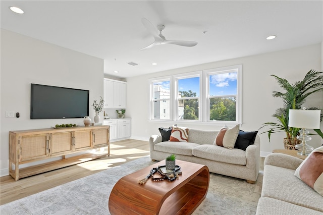 living room with light wood-type flooring and ceiling fan