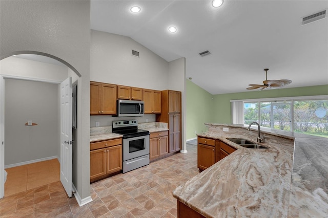 kitchen featuring sink, light stone countertops, stainless steel appliances, and ceiling fan