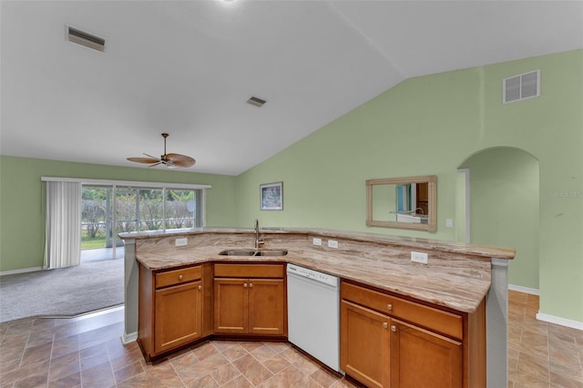 kitchen featuring white dishwasher, a center island with sink, sink, vaulted ceiling, and ceiling fan