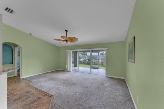 carpeted spare room with ceiling fan and lofted ceiling