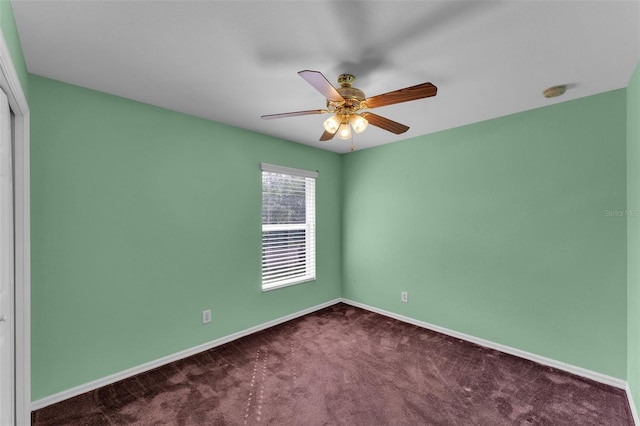 spare room featuring ceiling fan and carpet floors