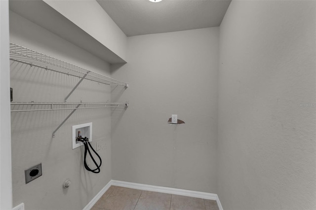 laundry room featuring hookup for a washing machine, electric dryer hookup, light tile patterned floors, and gas dryer hookup