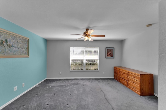 carpeted empty room featuring ceiling fan