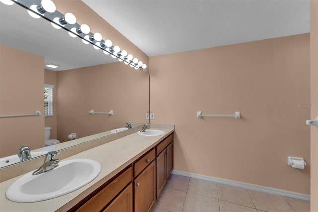 bathroom featuring vanity, toilet, and tile patterned flooring