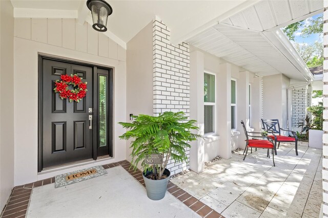 doorway to property with a porch