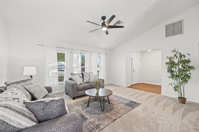 carpeted living room with high vaulted ceiling and ceiling fan