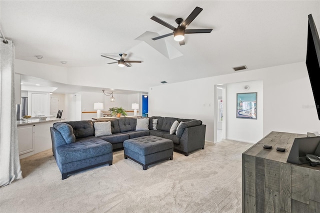 living room with light carpet, vaulted ceiling, and ceiling fan