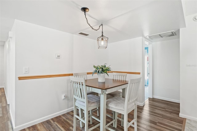 dining space with dark hardwood / wood-style flooring