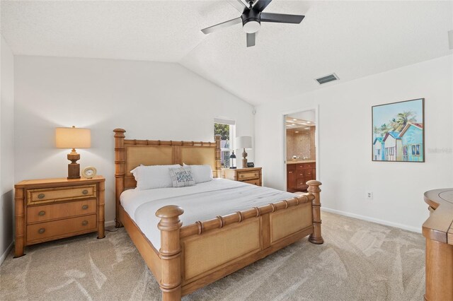 carpeted bedroom with connected bathroom, vaulted ceiling, and ceiling fan