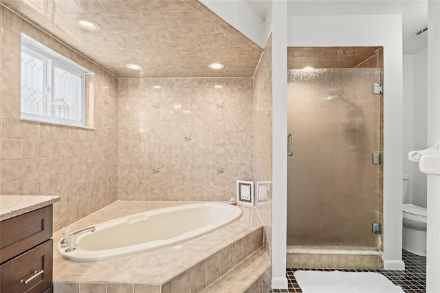 full bathroom featuring toilet, tile patterned floors, plus walk in shower, and vanity