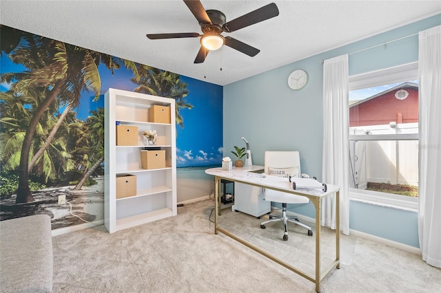 office with a healthy amount of sunlight, carpet floors, a textured ceiling, and ceiling fan