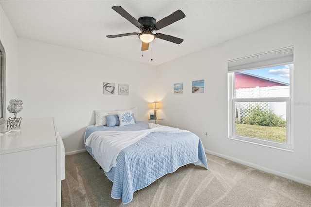 bedroom with dark colored carpet and ceiling fan