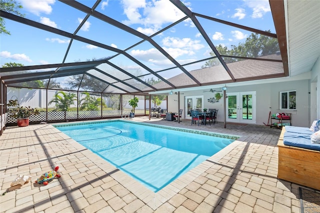 view of swimming pool with a patio area, french doors, ceiling fan, and glass enclosure