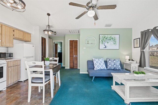 carpeted living room with ceiling fan with notable chandelier