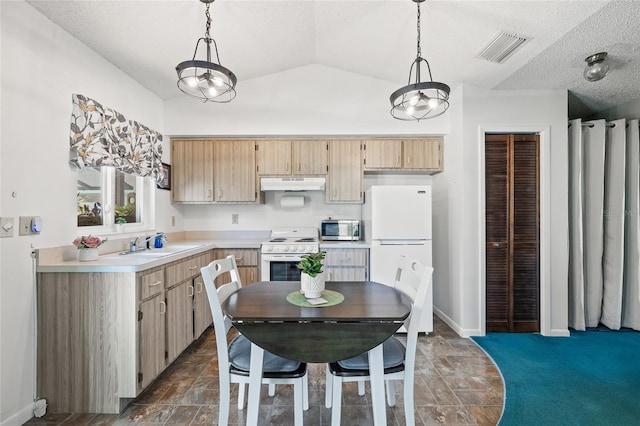 kitchen with an inviting chandelier, vaulted ceiling, pendant lighting, and white appliances