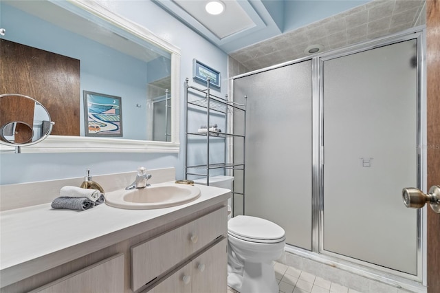 bathroom with vanity, toilet, tile patterned flooring, and a shower with door