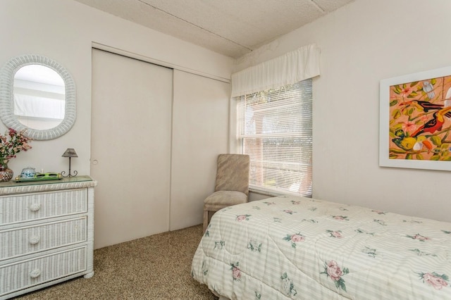 bedroom featuring a textured ceiling, a closet, and carpet flooring