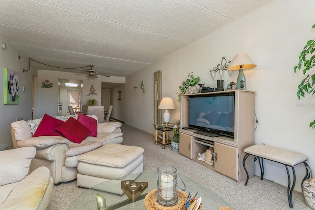 carpeted living room with a textured ceiling and ceiling fan