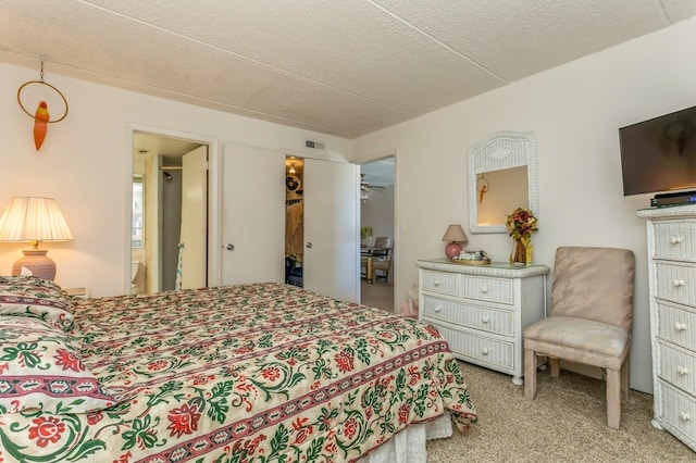 carpeted bedroom featuring a textured ceiling