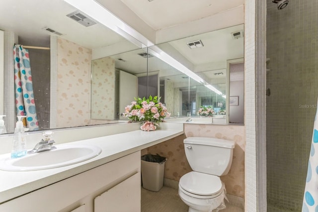 bathroom featuring vanity, toilet, and curtained shower