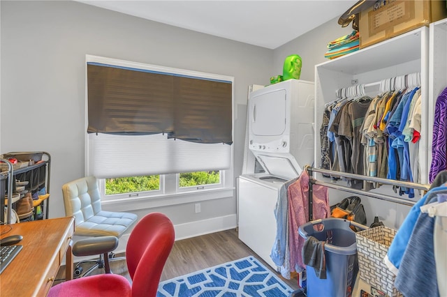 laundry area featuring hardwood / wood-style flooring and stacked washer and dryer