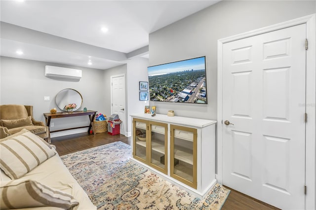 living room with a wall mounted air conditioner and dark hardwood / wood-style floors