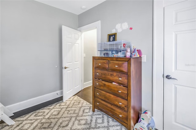 bedroom with dark wood-type flooring