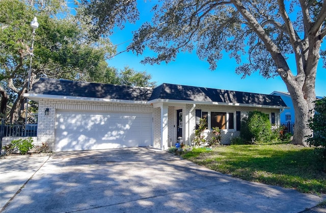 ranch-style house with a garage and a front lawn