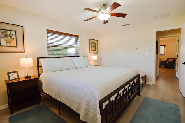 bedroom with light hardwood / wood-style floors and ceiling fan