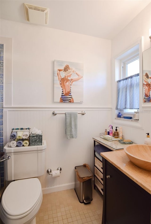 bathroom featuring vanity, toilet, and tile patterned floors