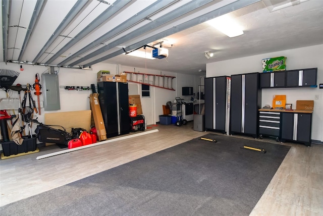 garage featuring a garage door opener and electric panel