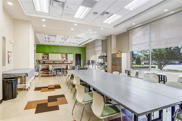 dining area with a towering ceiling