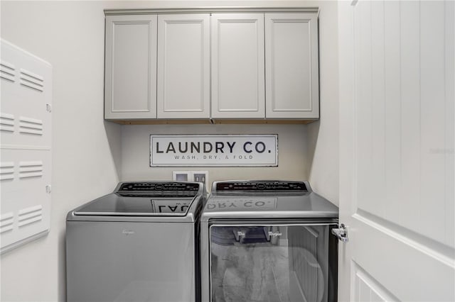 laundry room with cabinets and washer and clothes dryer