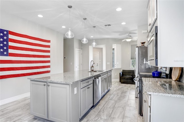 251 Tomelloso Way, Davenport, FL 33837 - kitchen with a sink, recessed lighting, a ceiling fan, a kitchen island with sink, and baseboards