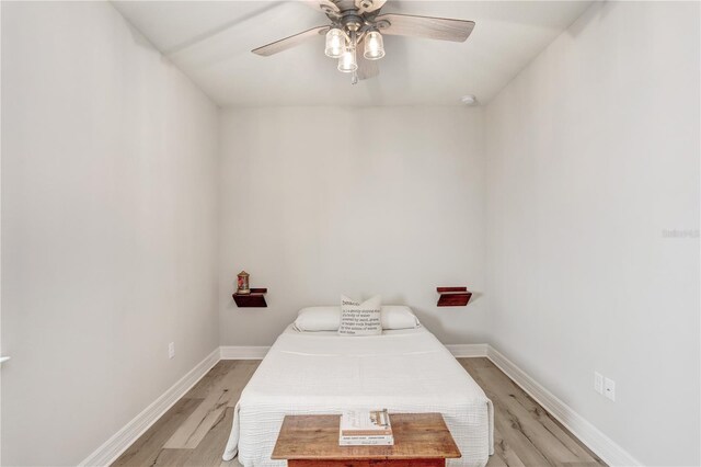 bedroom with light hardwood / wood-style floors and ceiling fan