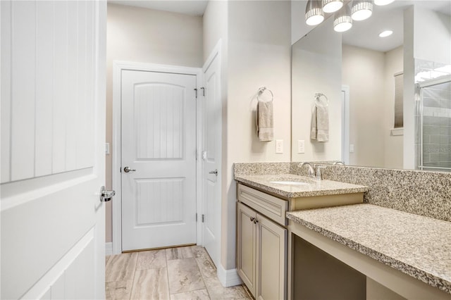 bathroom featuring vanity and an enclosed shower