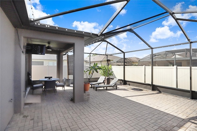 view of patio / terrace featuring a lanai