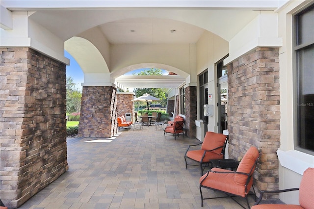 view of patio / terrace featuring an outdoor stone fireplace