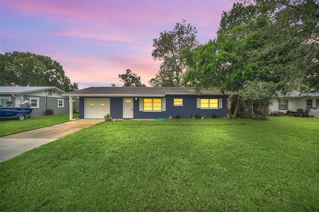 single story home with a yard and a garage