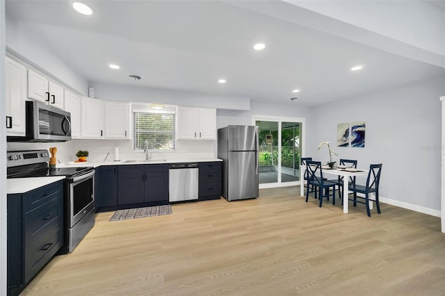 kitchen featuring a wealth of natural light, sink, white cabinetry, and stainless steel appliances