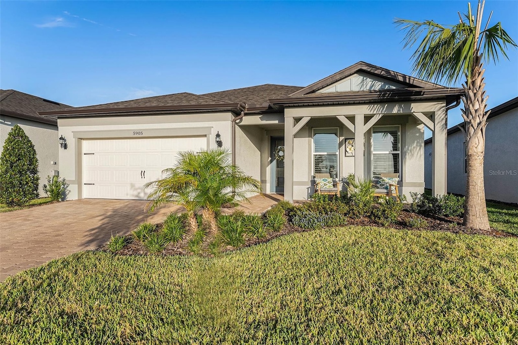 view of front of house with a garage and a front lawn