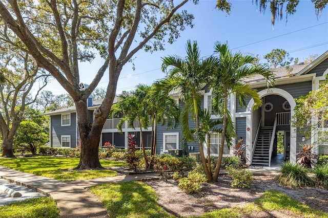 2101 Fox Chase Blvd Unit 106, Palm Harbor, FL 34683 - view of property featuring stairway and a front yard