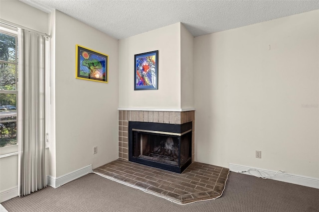 carpeted living room with a textured ceiling and a brick fireplace