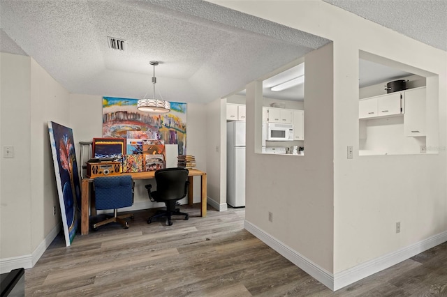 2101 Fox Chase Blvd Unit 106, Palm Harbor, FL 34683 - office space with wood finished floors, a textured ceiling, and baseboards