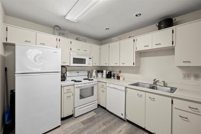 kitchen featuring light hardwood / wood-style flooring, white cabinetry, sink, and white appliances