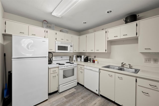 2101 Fox Chase Blvd Unit 106, Palm Harbor, FL 34683 - kitchen with white appliances, a sink, light wood-style floors, light countertops, and recessed lighting