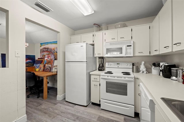 kitchen featuring a textured ceiling, white cabinetry, light wood-type flooring, sink, and white appliances