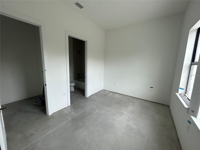 unfurnished bedroom with connected bathroom